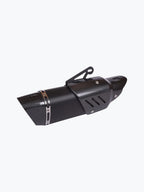 Black and carbon fiber motorcycle exhaust muffler with metal mounting bracket on white background