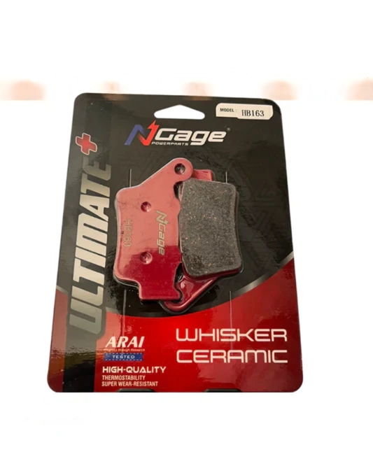 Red motorcycle brake pad labeled Whisker Ceramic, packaged for high-performance vehicles