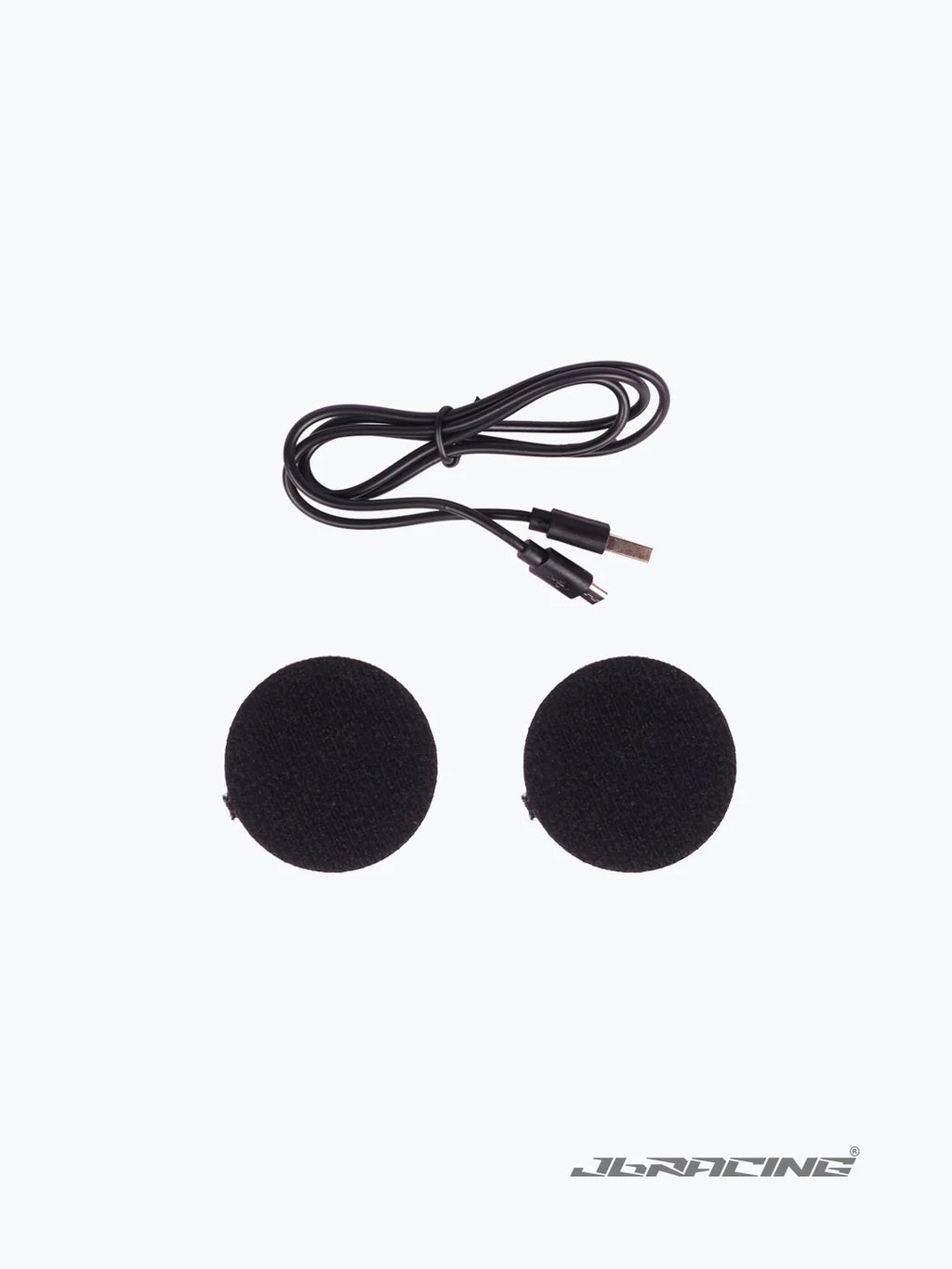 Motorcycle helmet speaker set with two round black speakers and charging cable on white background