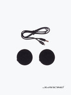 Motorcycle helmet speaker set with two round black speakers and charging cable on white background