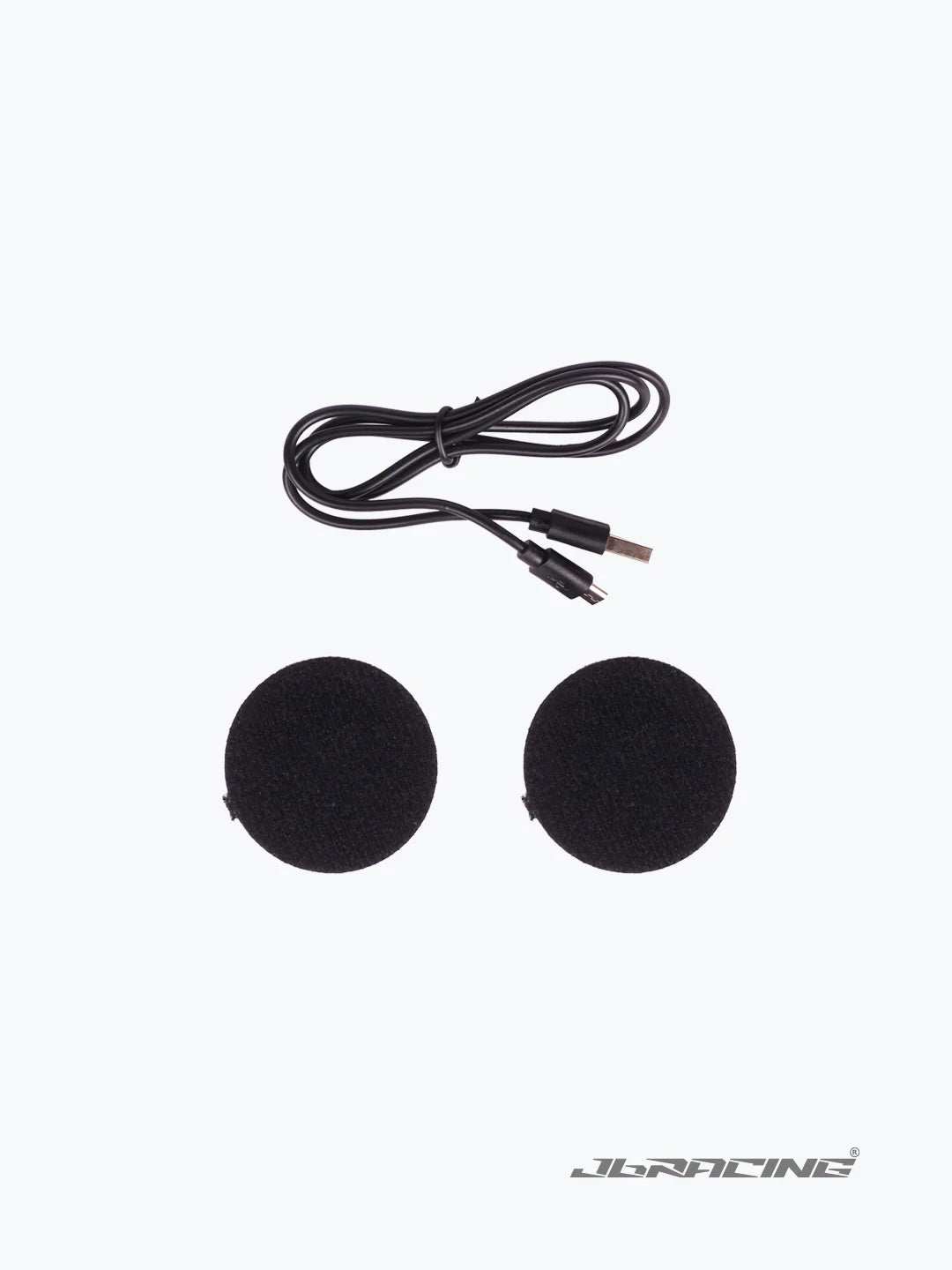 Motorcycle helmet speaker set with two round black speakers and charging cable on white background