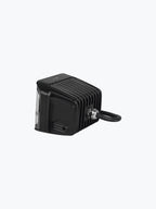 Black LED motorcycle auxiliary light with ribbed heat sink and wiring on a plain background