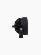 Black motorcycle LED headlight side view with mounting bracket on white background