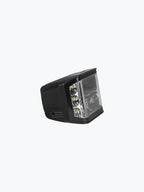 Black motorcycle LED headlight with clear lens on a white background