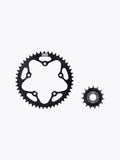 Black motorcycle sprocket set, large and small gears on white background