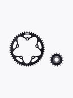 Black motorcycle sprocket set, large and small gears on white background