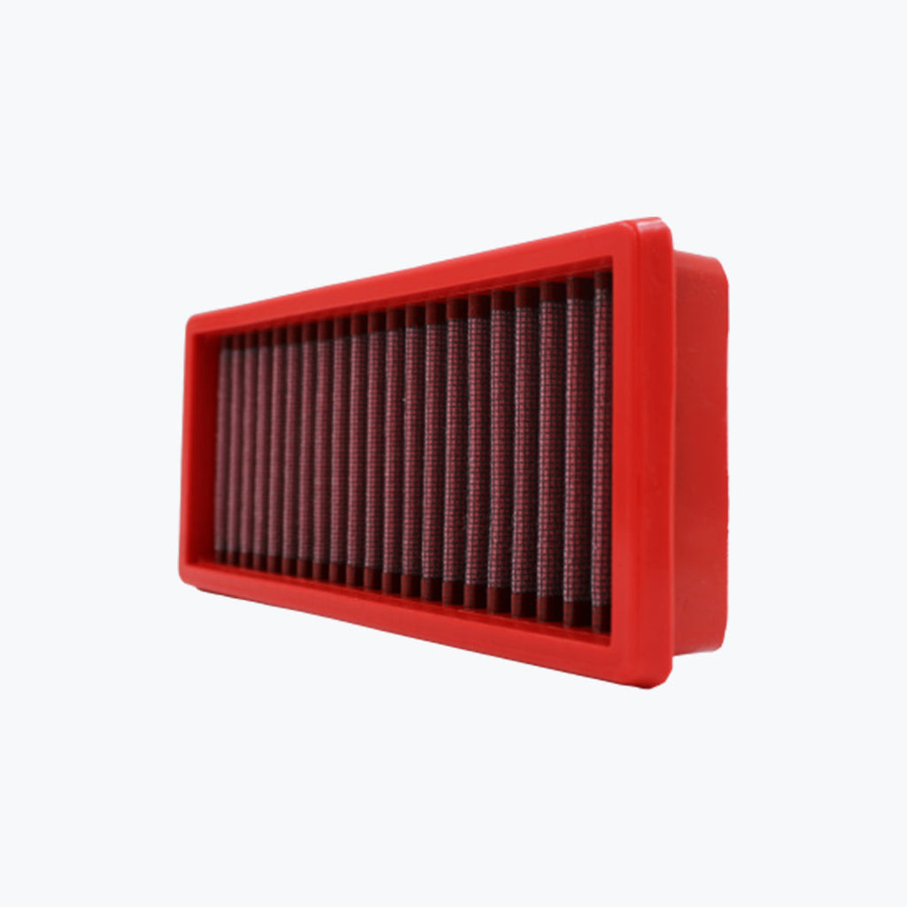 Rectangular red motorcycle air filter with pleated mesh on white background