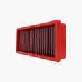 Rectangular red motorcycle air filter with pleated mesh on white background