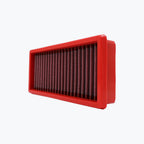 Rectangular red motorcycle air filter with pleated mesh on white background