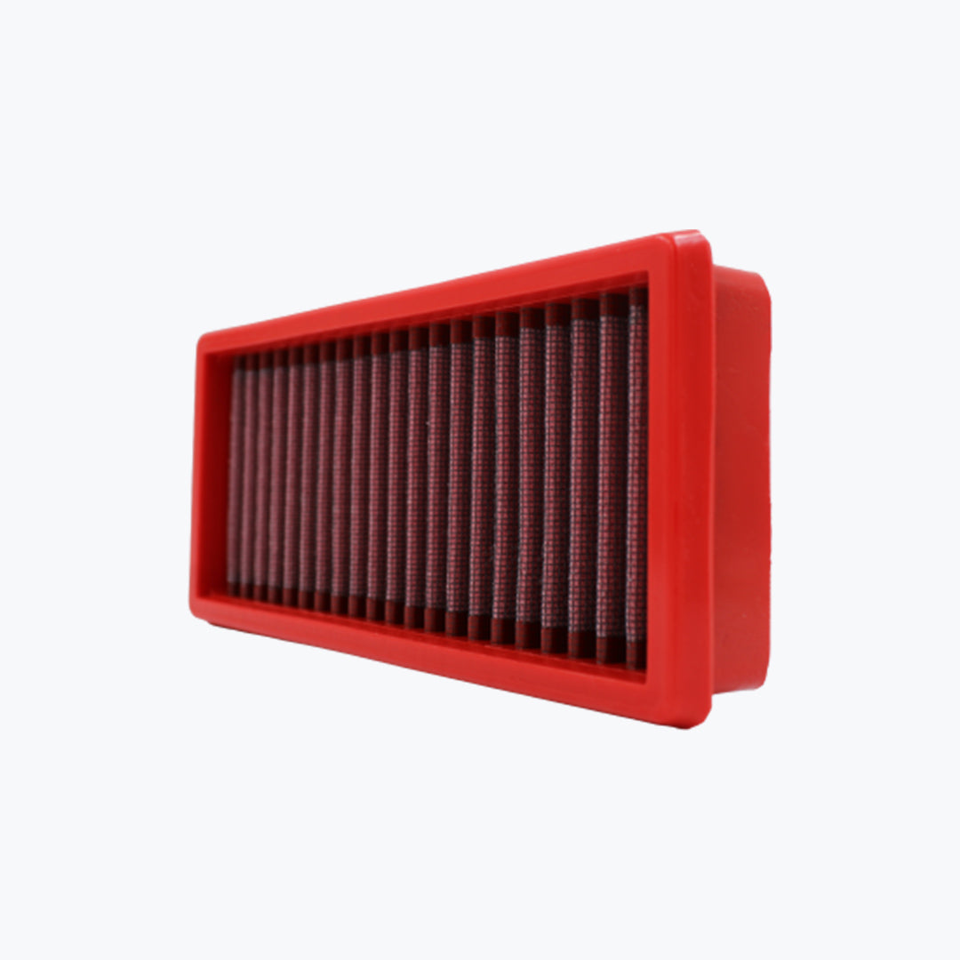 Rectangular red motorcycle air filter with pleated mesh on white background
