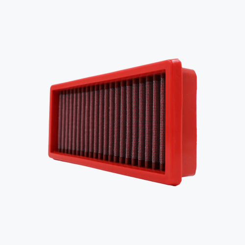 Rectangular red motorcycle air filter with pleated mesh on white background