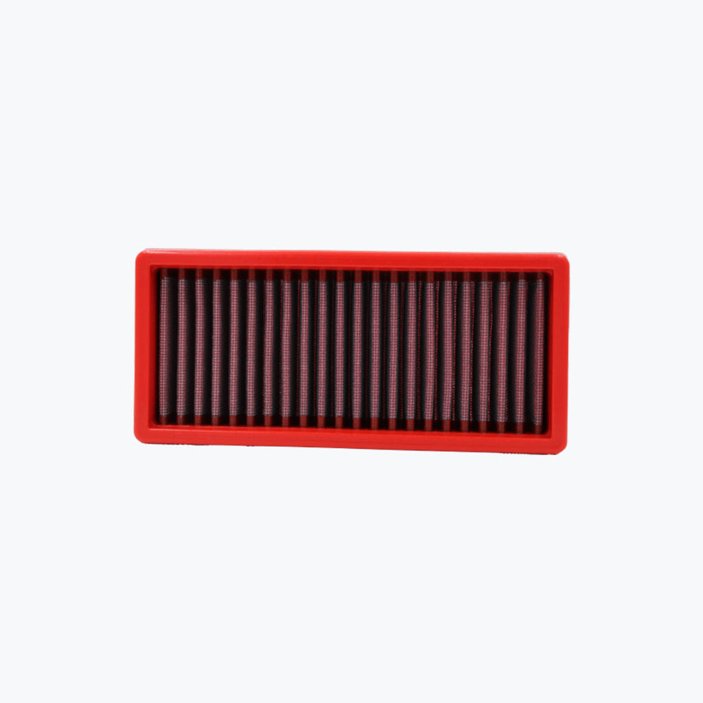 Rectangular red motorcycle air filter with pleated mesh on white background