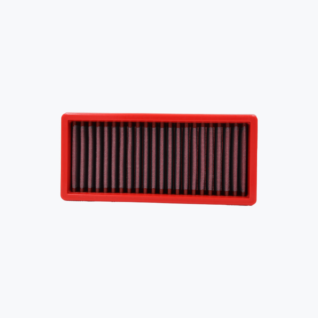 Rectangular red motorcycle air filter with pleated mesh on white background