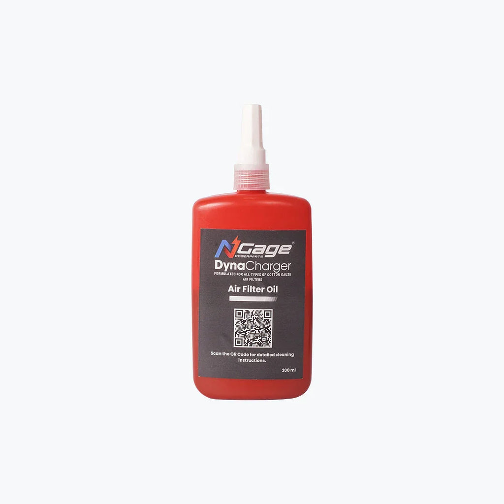 Red bottle of air filter oil for motorcycles with nozzle and product label on white background