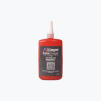 Red bottle of air filter oil for motorcycles with nozzle and product label on white background