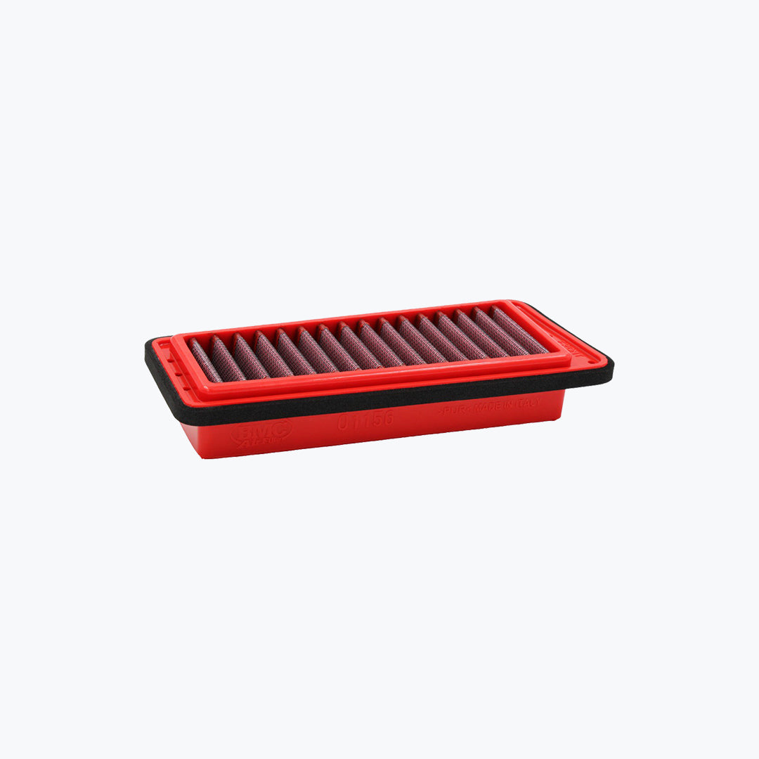 rectangular red motorcycle air filter with pleated design on a light background
