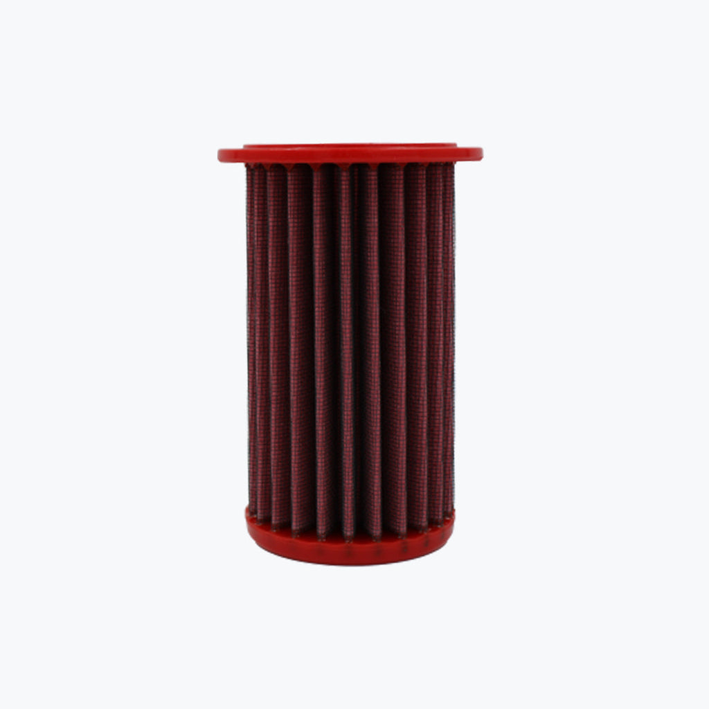 Red cylindrical motorcycle air filter on white background
