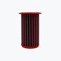 Red cylindrical motorcycle air filter on white background