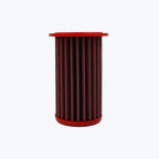 Red cylindrical motorcycle air filter on white background