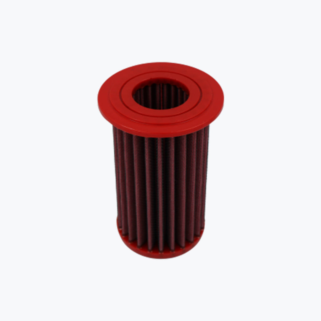 Red cylindrical motorcycle oil filter with pleated design on white background
