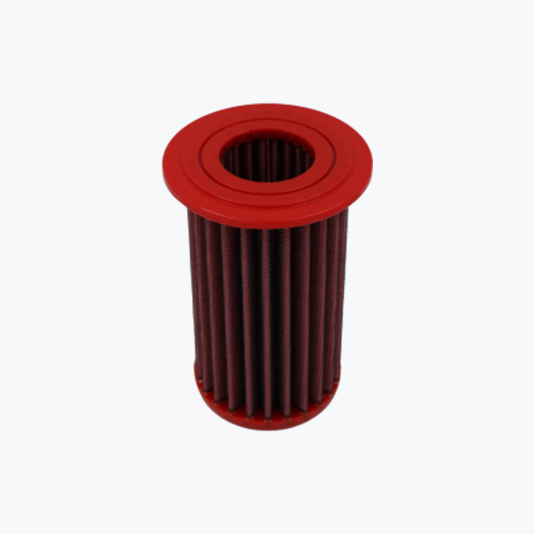 Red cylindrical motorcycle oil filter with pleated design on white background