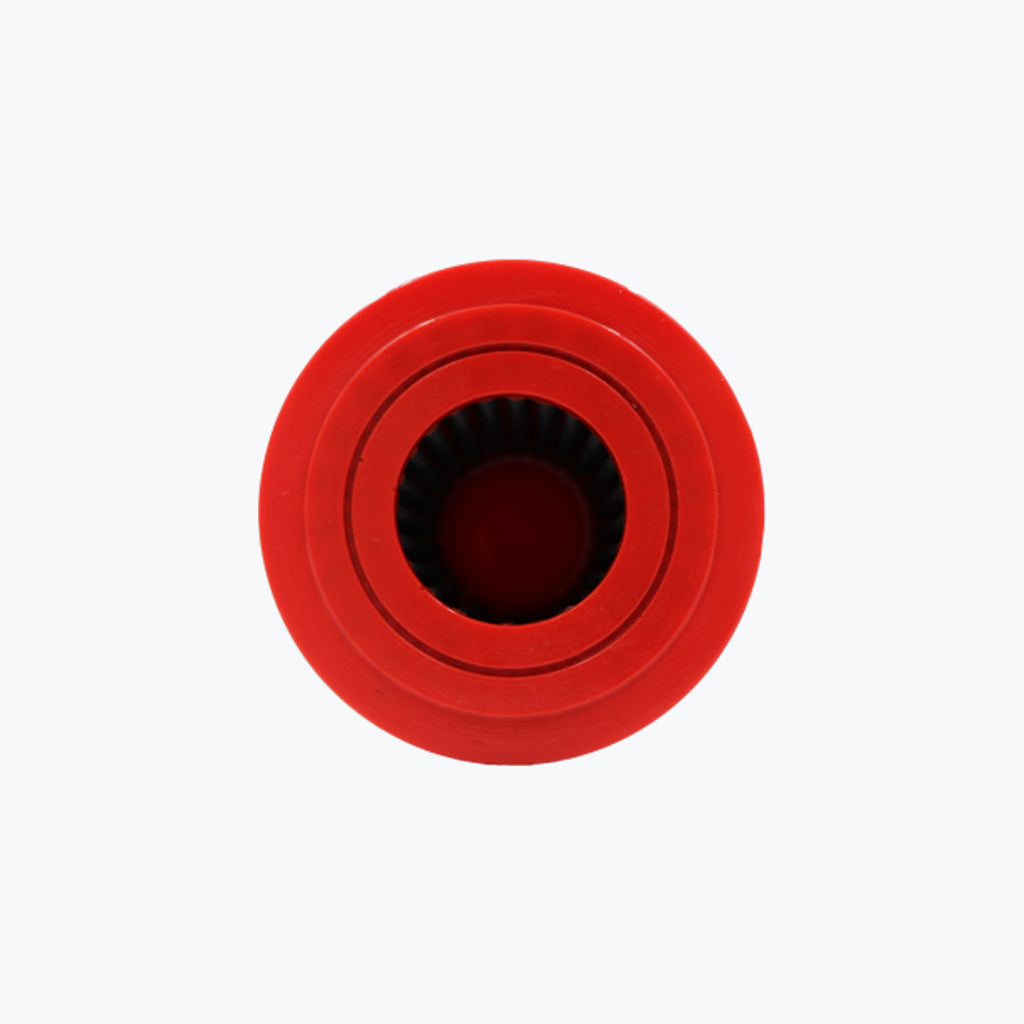 Red round motorcycle air filter top view with ribbed interior on white background