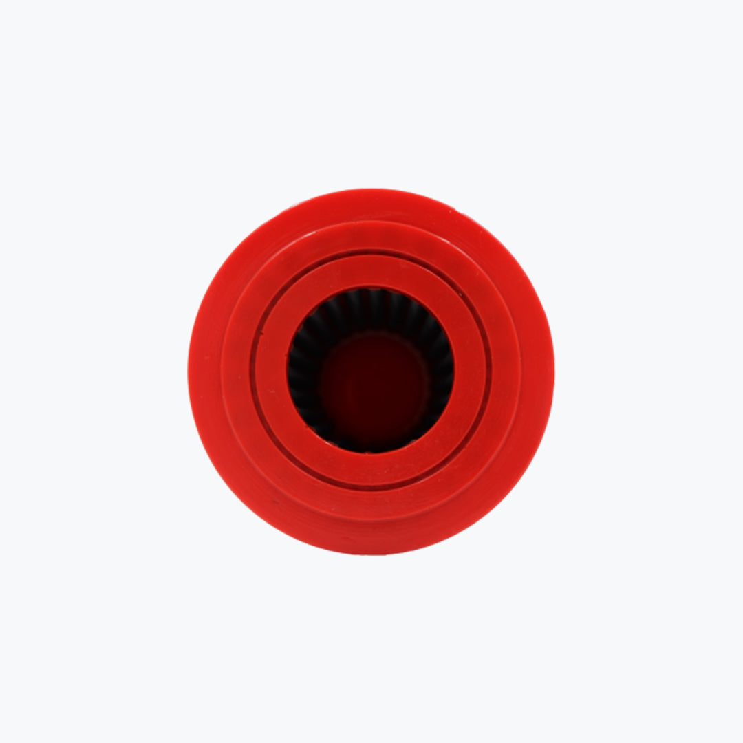 Red round motorcycle air filter top view with ribbed interior on white background