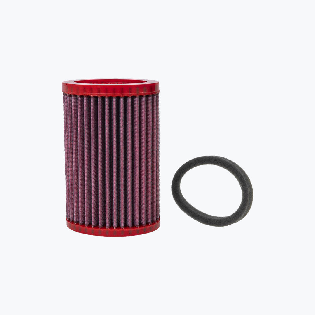 Red cylindrical motorcycle air filter with black gasket on white background