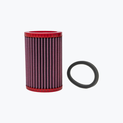 Red cylindrical motorcycle air filter with black gasket on white background