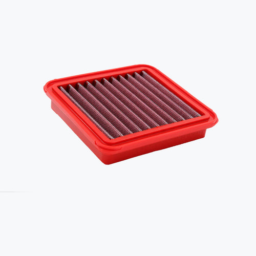 Red rectangular motorcycle air filter with pleated mesh on white background