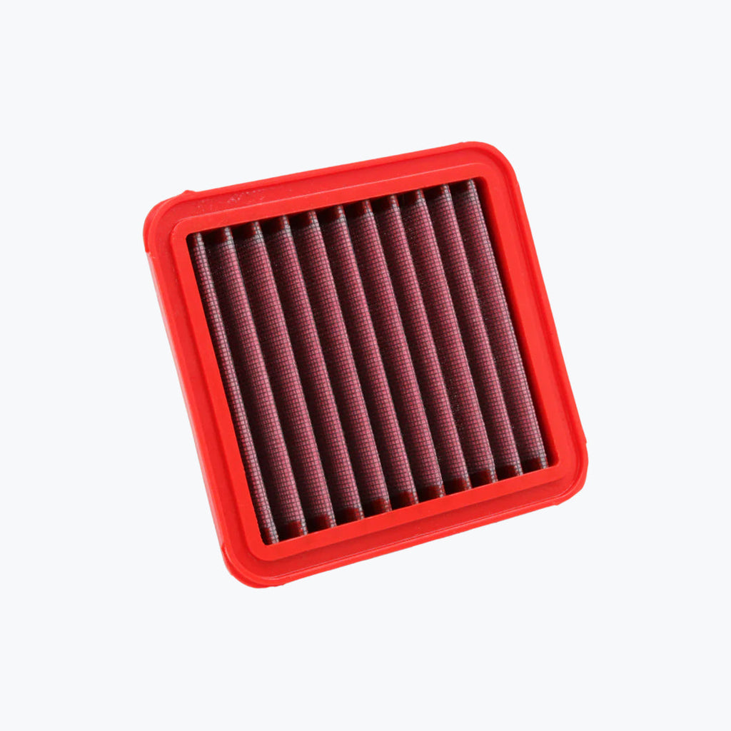 Red rectangular motorcycle air filter with pleated mesh design on white background