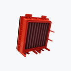 Red motorcycle air filter with pleated design on white background