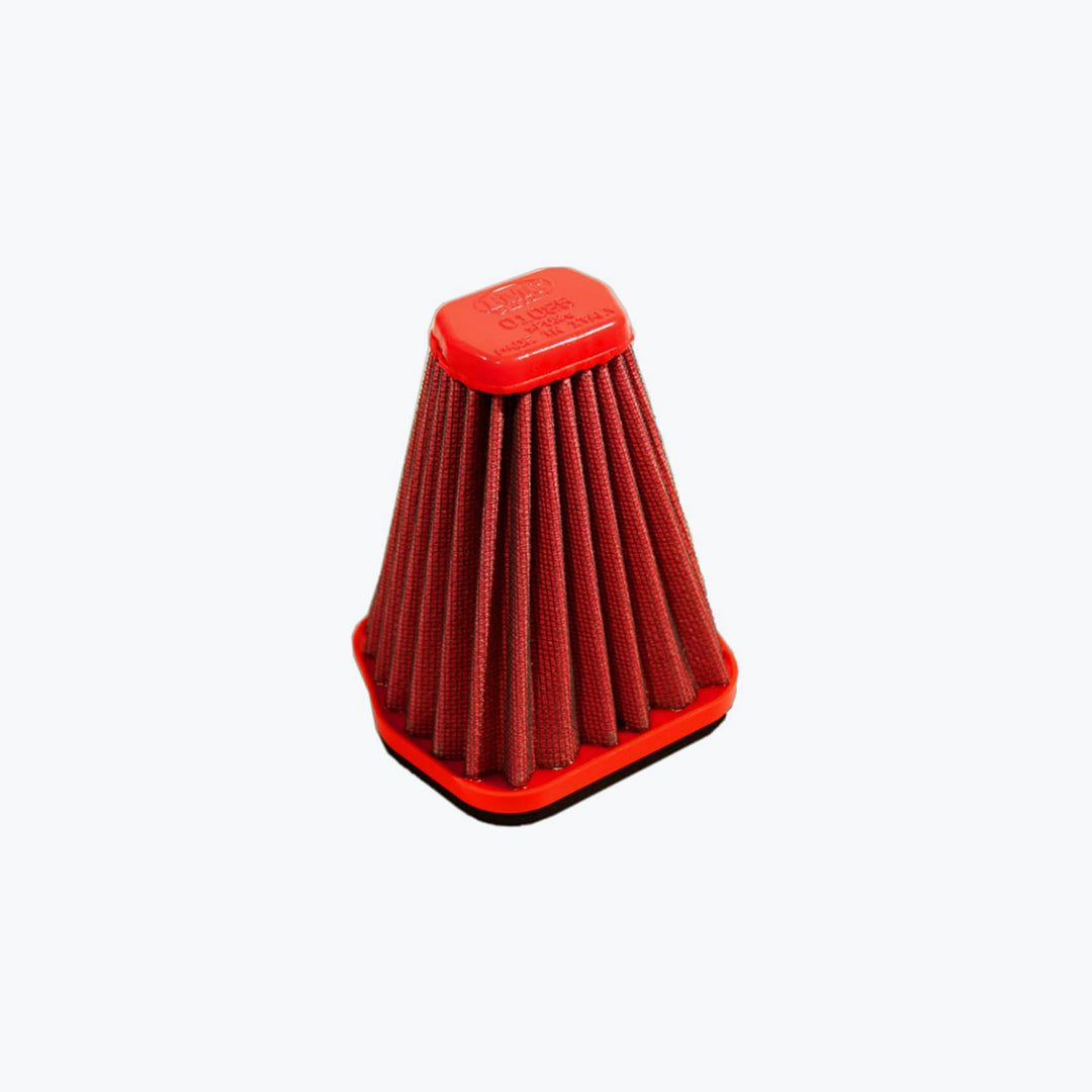 Red pleated motorcycle air filter with hexagonal top on light background