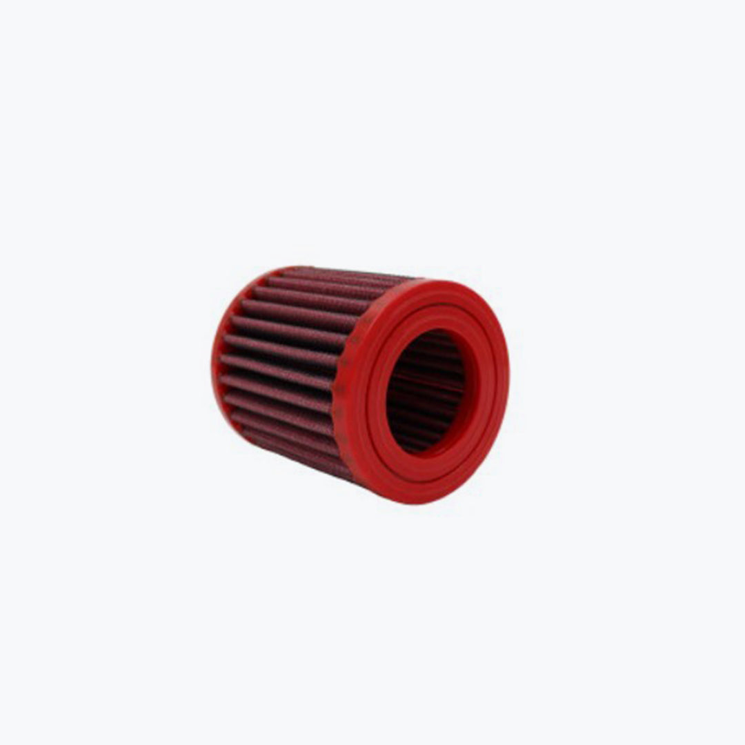 Red cylindrical motorcycle air filter with pleated element on white background