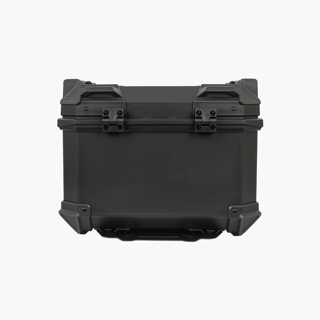 Black motorcycle top box with reinforced corners and backrest pad on white background