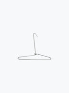Triangle-shaped metal hanger with curved hook on plain white background