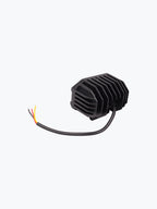Black motorcycle LED headlight with cooling fins and attached wiring on white background