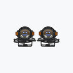 Pair of round LED motorcycle fog lights with mounting brackets on white background