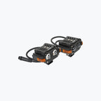 Pair of black motorcycle LED auxiliary lights with orange accents and wiring connectors
