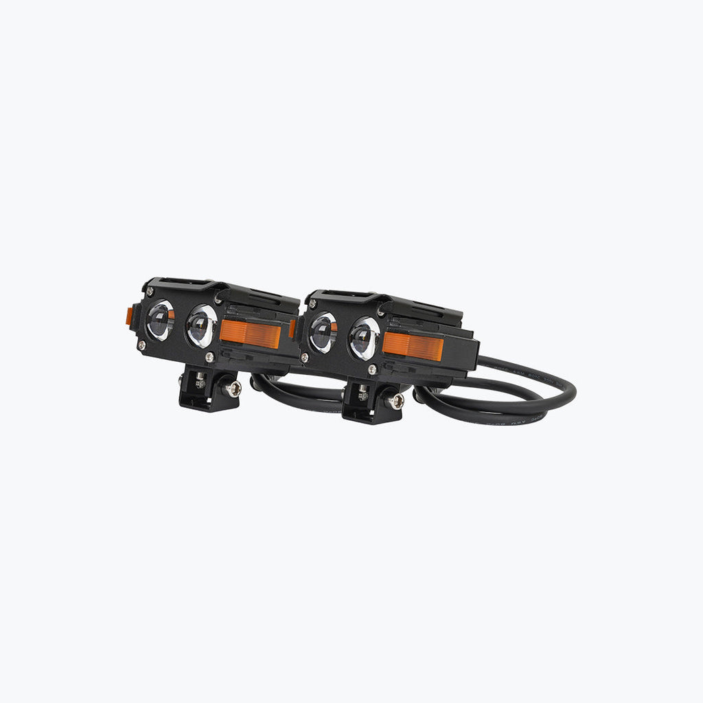 Pair of black LED motorcycle auxiliary lights with orange side markers and wiring