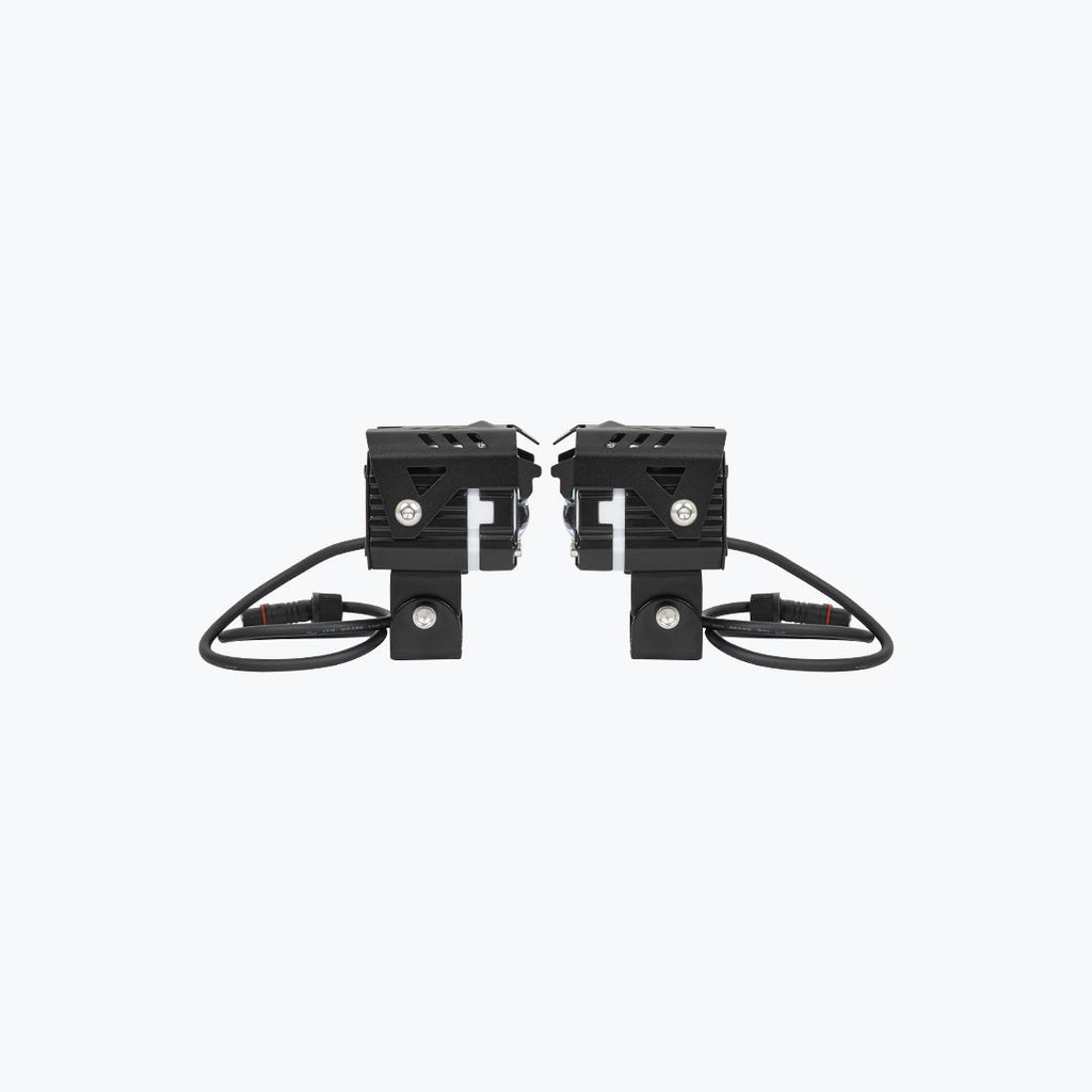 Pair of black motorcycle LED auxiliary lights with mounting brackets and cables on white background