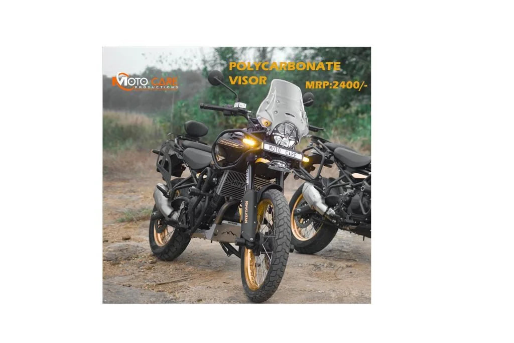Adventure motorcycle with polycarbonate visor, golden alloy wheels, outdoor setting