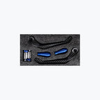 Carbon fiber motorcycle lever guards and blue aluminum handlebar ends set on foam insert