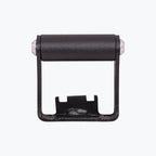 Black motorcycle chain roller guide with metal mounting bracket on white background