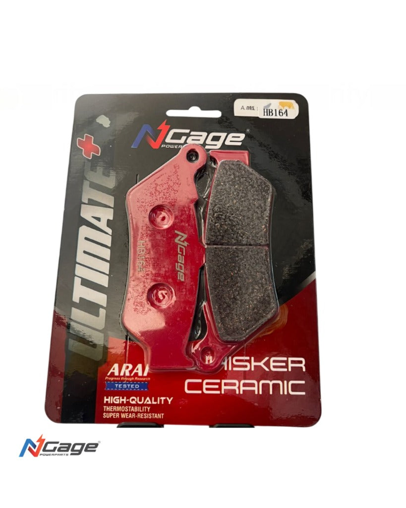 Red ceramic motorcycle brake pads in retail packaging, part number HB164, with textured friction surface.