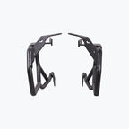 Black motorcycle saddle stay side mounts with angular metal brackets on white background