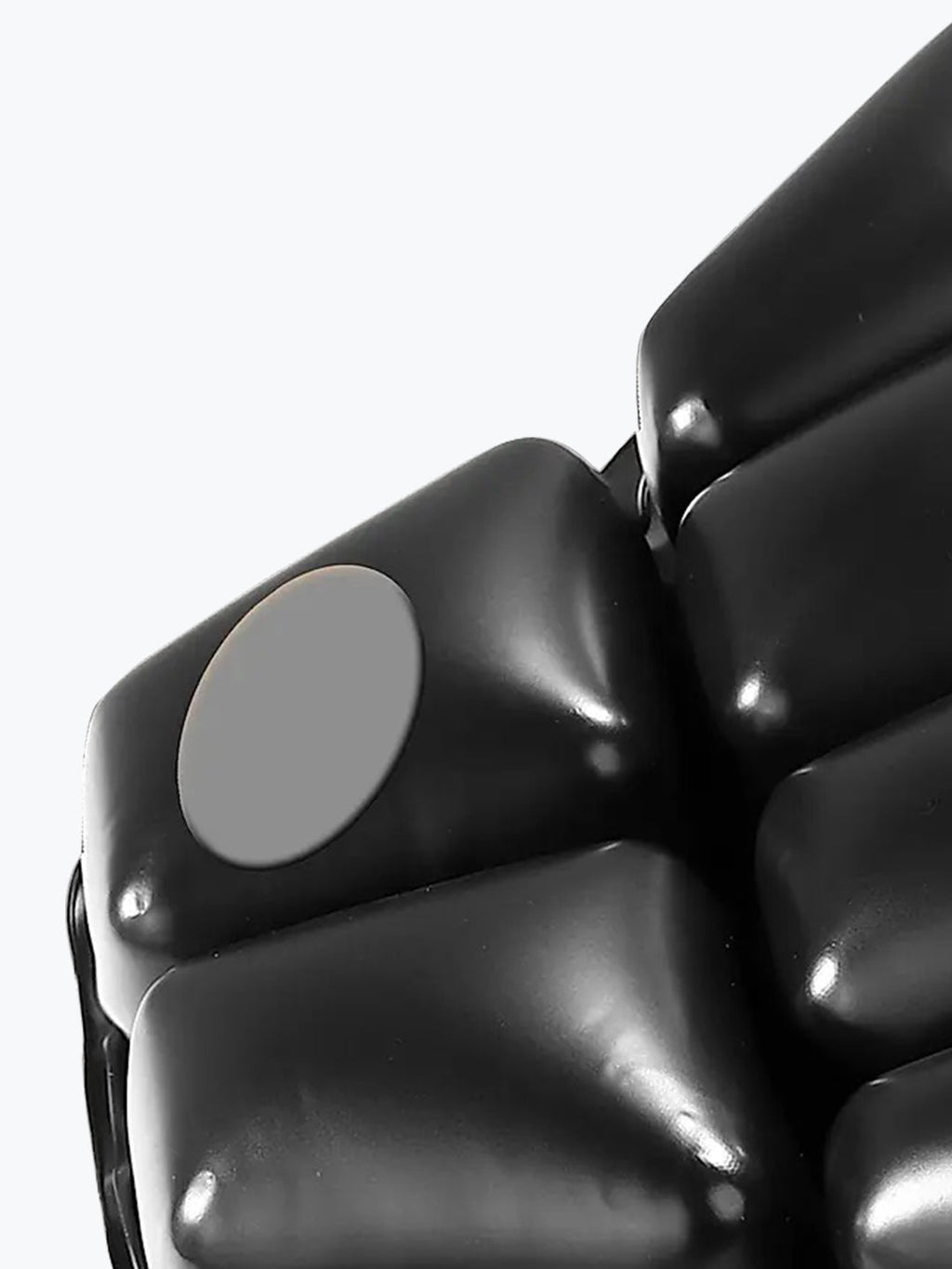 Close-up of black inflatable seat cushion with air valve for comfort and support.