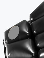 Close-up of black inflatable seat cushion with air valve for comfort and support.