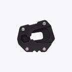 Black motorcycle side stand base plate with metal bolts on white background