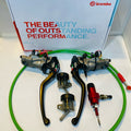 Brembo motorcycle brake lever set with green braided hoses and reservoirs on white background
